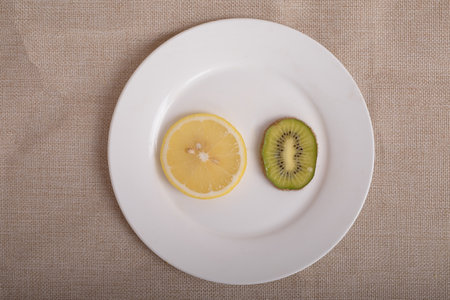 Fruit slices on a white plateの写真素材
