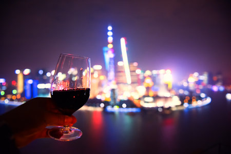shanghai night view with wine on handの写真素材