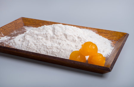 Yolks in a plate filled with flourの写真素材