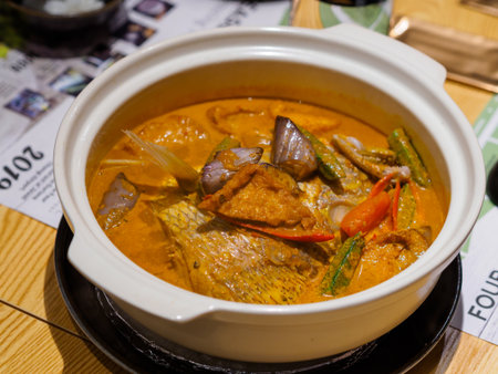 Southeast Asian fish and vegetable curry stewed with assorted vegetables at a restaurant in Singapore.の写真素材