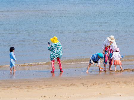 HAINAN, CHINA - MAR 2 2019 - Chinese tourist family on the beach in Hainan Island with copy spaceのeditorial素材