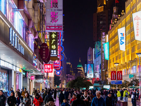 SHANGHAI, CHINA - 12 MAR 2019 - Night /Evening view of the shoppers and neon lights along the...