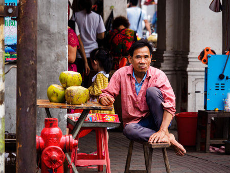 HAIKOU, HAINAN, CHINA - MAR 2 2019 - A street vendor selling coconut water, a popular local beverage.のeditorial素材