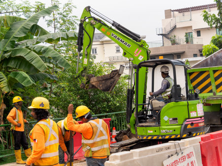 SINGAPORE - 3 MAY 2019 - Foreign construction workers at a road works site along Upper Thompson Rd in Singaporeのeditorial素材