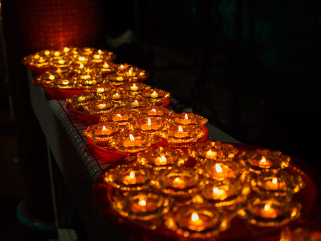SINGAPORE, 18 MAY 2019 - Close up of a row of Buddhist oil lamps in a temple at Vesak Day celebrations. Oil lamps symbolise wisdom and enlightenment in Buddhismのeditorial素材