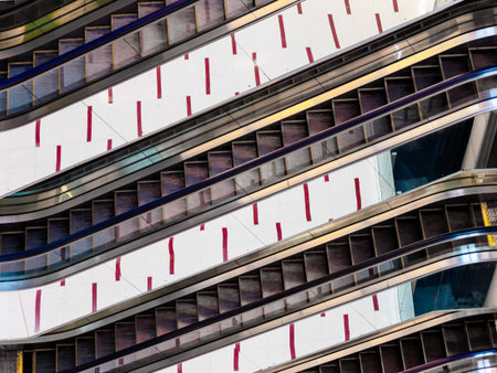 SINGAPORE â 20 MAR 2019 â Close up of escalators in the interior of Cuppage Plaza, Singapore. The escalators reflect the floor tiles to form a geometric pattern. Abstract / Geometric architecture conceptのeditorial素材