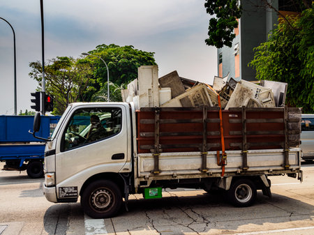 SINGAPORE â 3 MAY 2019 â A pick-up truck with a full load of discarded air-conditioners / air-con / scrap metal on a motorwayのeditorial素材