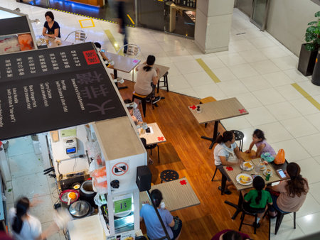 SINGAPORE â 30 MAR 2020 â Social distancing markers on eatery tables at a cafe. The markers remind diners to sit apart from others to stop covid-19 / coronavirus transmissionのeditorial素材