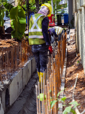 SINGAPORE â€“ 3 MAR 2020 â€“ Construction workers in high visibility protective gear...