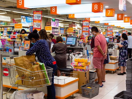 SINGAPORE â€“ 9 APR 2020 â€“ People wearing masks at the busy check-out counters of NTUC...