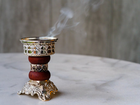 Ornate Arabian Bakhoor incense burner / censer emitting white smoke. With copy spaceの写真素材