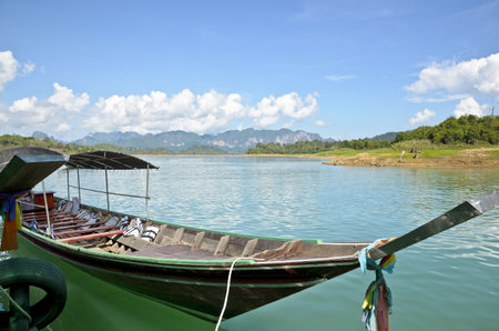 Long-tail boat waiting for the tourists  Ratchaprapa or Chiao Lan Dam , Surat Thani Province Thailandの写真素材