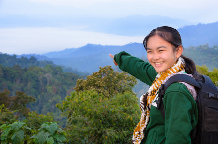 Tourist girl on the mountain in the morning at Panoen Thung scenic point Kaeng Krachan National Park Phetchaburi province Thailandの写真素材