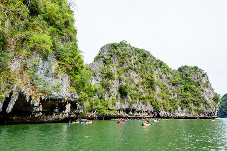 PHANG NGA THAILAND  APRIL 27 2015: Tourists are happy with the canoeing near island on the sea surface at Tham Lod cave in Ao Phang Nga Bay National Park APRIL 27 2015 in Thailandのeditorial素材