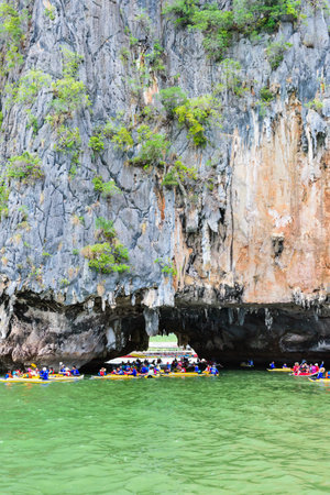PHANG NGA THAILAND  APRIL 27 2015: Tourists are happy with the canoeing near island on the sea surface at Tham Lod cave in Ao Phang Nga Bay National Park APRIL 27 2015 in Thailandのeditorial素材