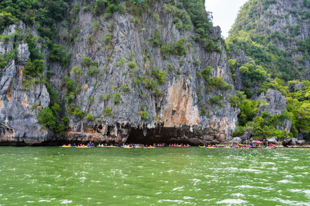 PHANG NGA THAILAND  APRIL 27 2015: Tourists are happy with the canoeing near island on the sea surface at Tham Lod cave in Ao Phang Nga Bay National Park APRIL 27 2015 in Thailandのeditorial素材