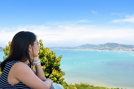 Side of the women tourist looking at beautiful nature sea and island on Khao-Khad mountain viewpoint famous attractions in Phuket Province, Thailandの写真素材