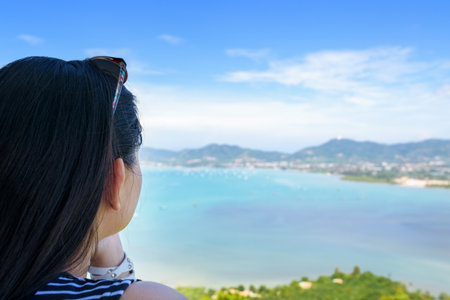 Back side the women tourist looking at beautiful landscape of sea and island on Khao Khad mountain viewpoint famous attractions in Phuket Province, Thailandの写真素材