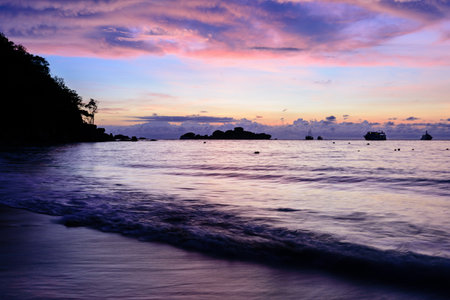 Beautiful colors of morning sky before sunrise on the beach at Honeymoon Bay is a famous attractions for diving on Ko Miang island in Mu Koh Similan National Park, Phang Nga Province, Thailandの写真素材