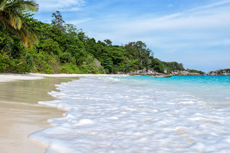 Beautiful nature of blue sea sand and white waves on the beach during summer at Koh Miang island in...