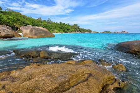 Beautiful landscape of blue sky sea and white waves on beach near the rocks during summer at Koh...
