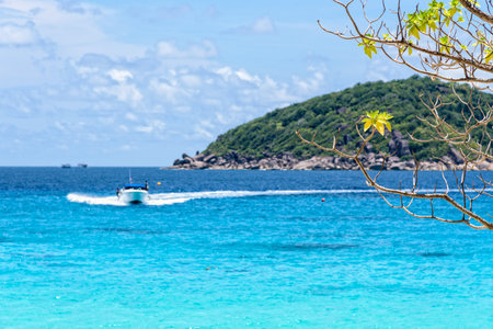 Beautiful landscape of blue sea and speed boat taking tourists traveling to Koh Miang Island under the summer sky for background in Mu Ko Similan National Park, Phang Nga Province, Thailandの写真素材