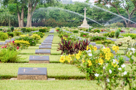 KANCHANABURI, THAILAND - MAY 3, 2014: Chungkai War Cemetery this is historical monuments where to respect prisoners of the World War 2 who rest in peace here, MAY 3, 2014 in Thailandのeditorial素材