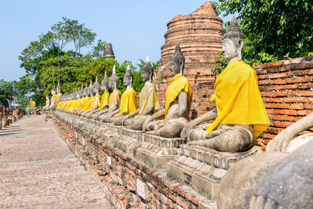 Row of Buddha statue sitting at Wat Yai Chaimongkol temple in Phra Nakhon Si Ayutthaya Historical Park, Ayutthaya Province, Thailandの写真素材