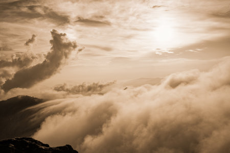 Sepia color vintage style Beautiful landscape nature of high mountain fog cloud and sky in winter from viewpoint Phu Chi Fa Forest Park at Chiang Rai Province, Thailandの写真素材