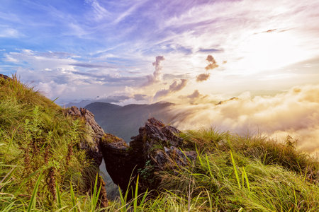 Beautiful landscape nature of high mountain colourful sunlight cloud and sky on Phi Pan Nam Range during sunset in winter from viewpoint Phu Chi Fa Forest Park at Chiang Rai Province Thailandの写真素材