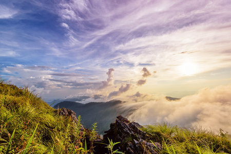 Beautiful landscape nature of high mountain colourful sunlight cloud and sky on Phi Pan Nam Range during sunset in winter from viewpoint Phu Chi Fa Forest Park at Chiang Rai Province Thailandの写真素材