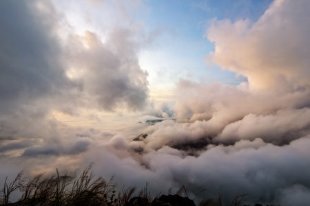 Beautiful nature sky scape cloud and fog in sunrise on peak mountains in winter at Phu Chi Fa Forest Park, Chiang Rai, Thailandの写真素材