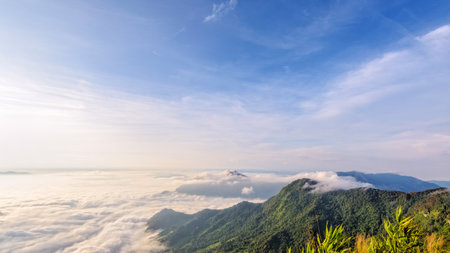 Beautiful landscape nature in morning on peak mountain with sunlight cloud fog and bright blue sky in winter at Phu Chi Fa Forest Park is a famous tourist attraction of Chiang Rai Province, Thailandの写真素材