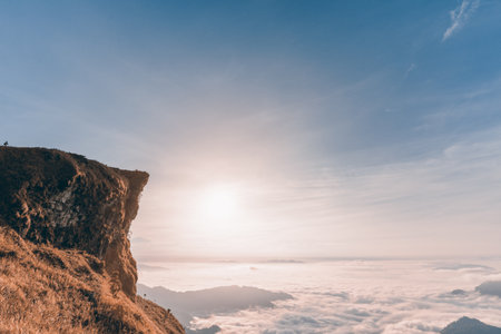 Vintage style in Sienna-Blue color two tone, beautiful landscape nature of sunrise on peak mountain with cloud fog and sky in winter at Phu Chi Fa Forest Park, Chiang Rai Province, Thailandの写真素材
