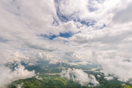 Beautiful natural landscape from high angle view of Mekong River forest and white clouds in the sky on the mountain at Doi Pha Tang view point, Chiang Rai Province, Thailandの写真素材