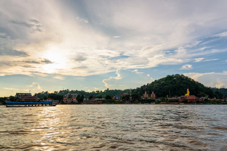 Beautiful natural landscape and tourist boat cruising the beauty of the Mekong River coast at sunset in the Golden Triangle Park (Sob Ruak) in Chiang Rai Province, Thailandの写真素材