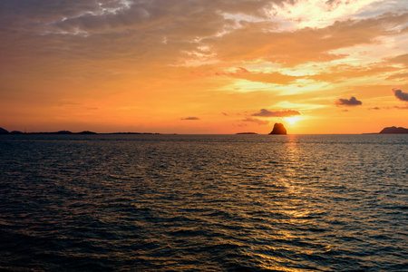 Beautiful natural landscape of colorful cloud sky and sun at sunset over the sea in Surat Thani province, Thailandの写真素材