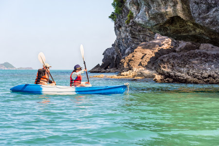 Two women are mother and daughter. Travel by boat with a kayak happy under the blue sky summer around Ko Phi view the beautiful nature of the sea and island, Mu Ko Ang Thong National Park, Surat Thani, Thailandの写真素材