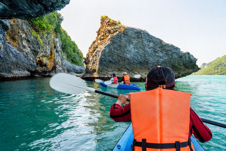 Group of tourists on a kayak.Travel by boat around Ko Phi enjoy the beautiful nature of the sea and islands in the summer at Mu Ko Ang Thong National Marine Park in Gulf of Thailand, Surat Thani provinceの写真素材