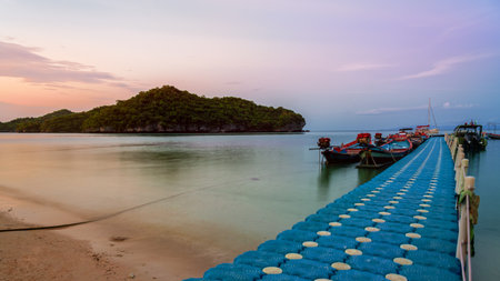 Floating bridge pier for tourist on the beach in front of Ko Wua Ta Lap island view Ko Phi during sunset at Mu Ko Ang Thong National Marine Park in Gulf of Thailand, Surat Thani province,16:9 widescreenの写真素材