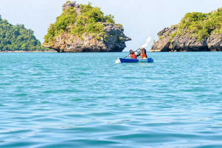 Two women are mother and daughter. Travel by boat with a kayak around island enjoy view the beautiful natural landscape of the blue sea at summer, Mu Ko Ang Thong National Park, Surat Thani, Thailandの写真素材