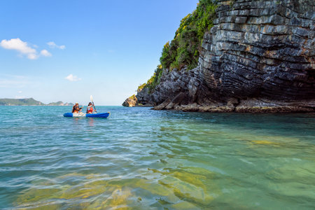 Two women are mother and daughter. Travel by boat with a kayak happy under the blue sky summer around Ko Phi view the beautiful nature of the sea and island, Mu Ko Ang Thong National Park, Surat Thani, Thailandの写真素材