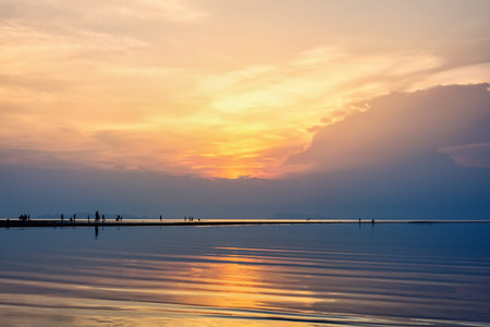 Silhouette of people relaxing on the beach watching the beautiful natural landscape colorful of the sky and the sea during a sunset at Nathon Sunset Viewpoint in Ko Samui island, Surat Thani, Thailandの写真素材