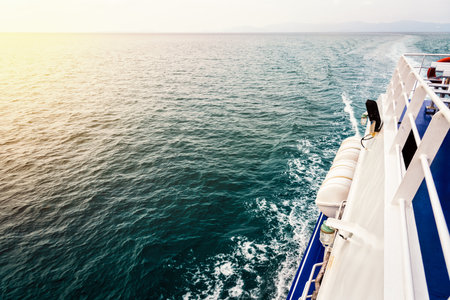 Travel boat sailing on the ocean during sunset in Thailandの写真素材