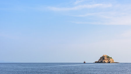 Beautiful nature landscape of Shark Island Divesite small rock island at Ko Tao under the blue sky on the sea in summer is a famous attractions in the Gulf of Thailand, Surat Thani, 16:9 widescreenの写真素材