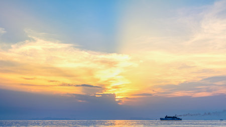Beautiful natural landscape of large travel boat sailing on the sea with colorful sky during sunset background in Thailand, 16:9 widescreenの写真素材