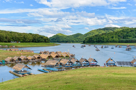 Beautiful natural landscape of the river, mountain, blue sky, green forest and bamboo raft shelter is part of the floating restaurant at Huai Krathing is a tourist attraction of Loei province, Thailandの写真素材