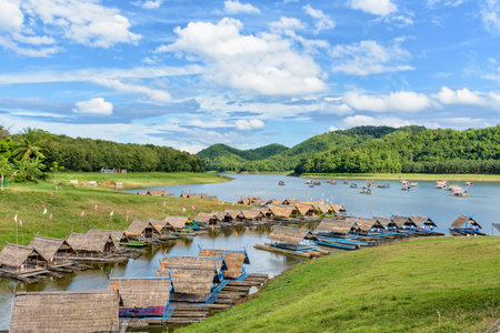 Beautiful natural landscape of the river, mountain, blue sky, green forest and bamboo raft shelter is part of the floating restaurant at Huai Krathing is a tourist attraction of Loei province, Thailandの写真素材