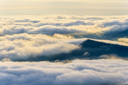 Beautiful nature landscape clouds and fogs like the sea is covered peaks in winter morning during sunrise at viewpoint of Phu Ruea National Park, Loei province, Thailandの写真素材