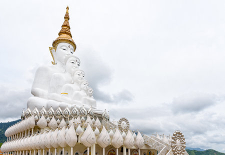 Buddha statue has large white five body on mountain surrounded by nature with cloud fog cover at Wat Phra That Pha Sorn Kaew Temple is a tourist attractions in Khao Kho, Phetchabun, Thailandの写真素材
